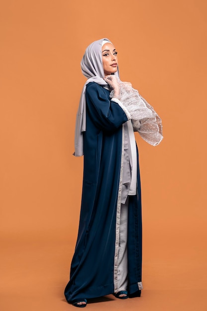 Gorgeus muslim woman looking at camera posing in studio. She's serious.