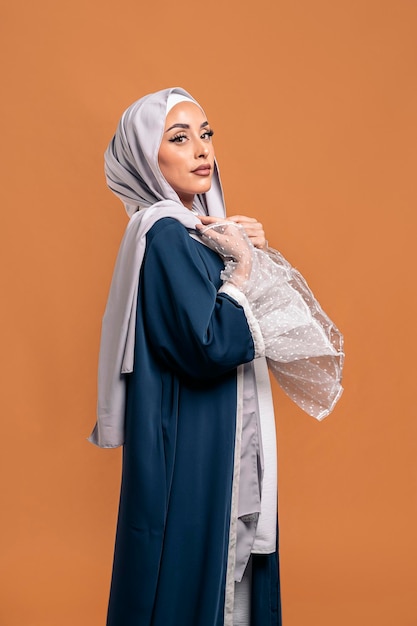 Gorgeus muslim woman looking at camera posing in studio. She's serious.