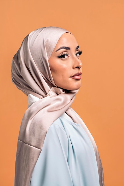 Gorgeus muslim woman looking at camera posing in studio. She's serious.