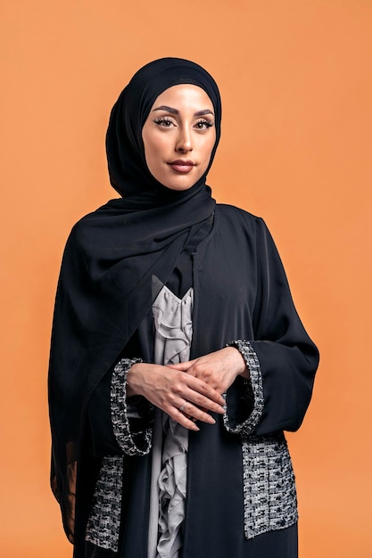 Gorgeus muslim woman looking at camera posing in studio. She's serious.