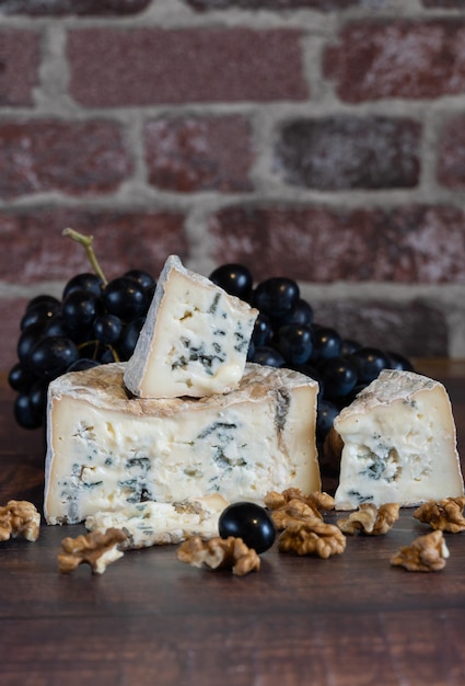 Gorgonzola blue mold cheese with grapes and nuts. Handmade.