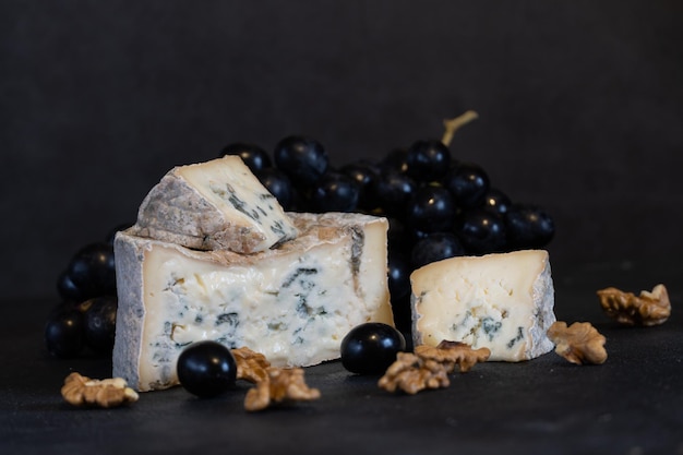 Gorgonzola blue mold cheese with grapes and nuts. Handmade.