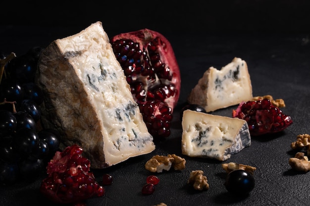 Gorgonzola blue mold cheese with pomegranate, grapes and nuts.