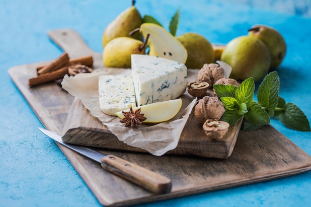 Gorgonzola picant Italian blue cheese, made from unskimmed cow's milk in North of Italy. Piece of blue mould cheese danablu,  roquefort with pear and walnuts