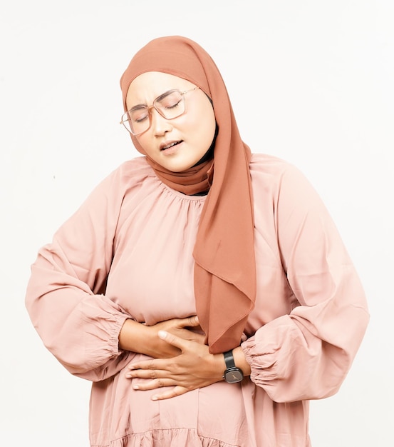 Got Stomachache Gesture of Beautiful Asian Woman Wearing Hijab Isolated On White Background