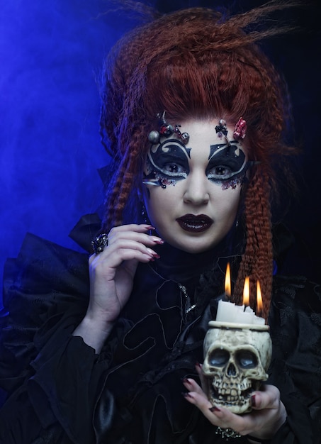 Gothic vampire redhair  woman with skull.