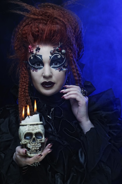 Gothic vampire woman with skull, close up