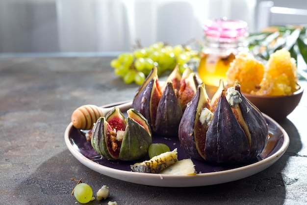 Gourmet appetizer of baked figs with goat cheese,walnuts and honey 