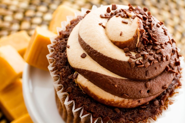 Gourmet chocolate caramel swirl cupcake with chocolate sprikles.