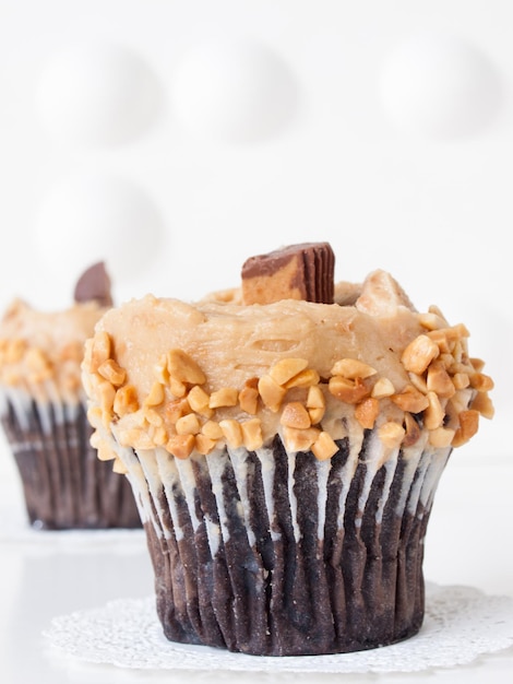 Gourmet Reese's peanut butter cups cupcake on white backround.