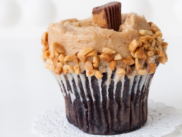 Gourmet Reese's peanut butter cups cupcake on white backround.