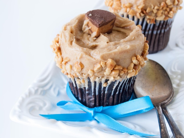 Gourmet Reese's peanut butter cups cupcake on white backround.