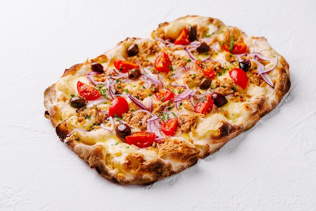 Gourmet tuna and tomato pizza on white background