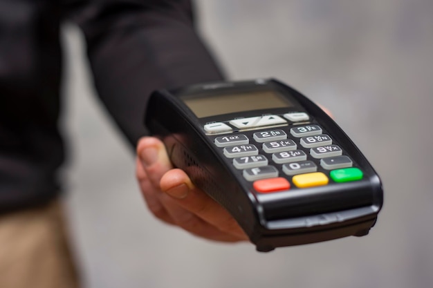 GPRS payment POS terminal on a table with a laptop Equipment for payment by bank cards