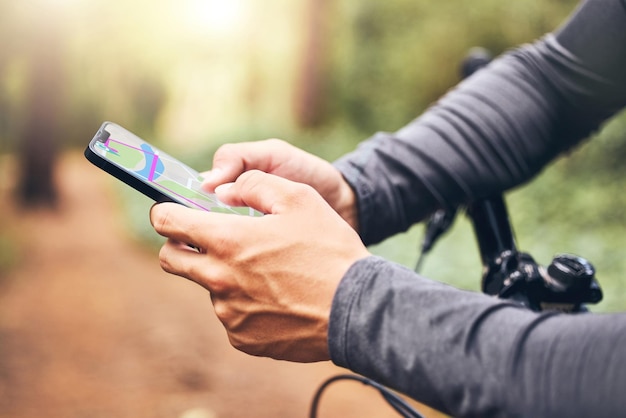 Gps map and cyclist with smartphone for digital travel guidance in nature fitness trail Mobile technology for cycle safety security and help for man travelling in remote location