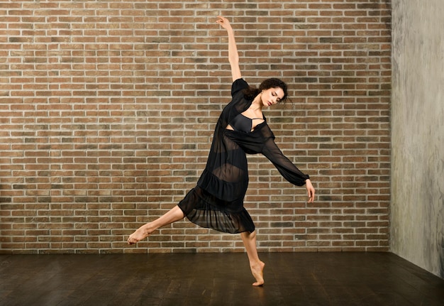 Graceful ballerina dancing in studio