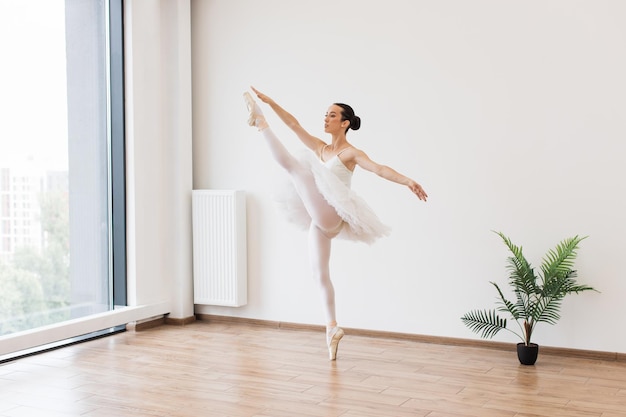 Graceful classical female dancer stretching her legs