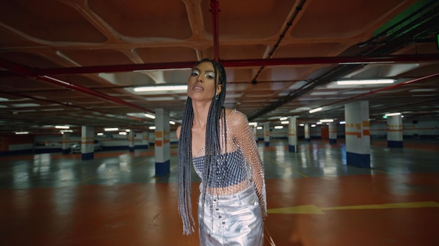 Graceful dreadlocks model stepping dark parking place african brunette posing