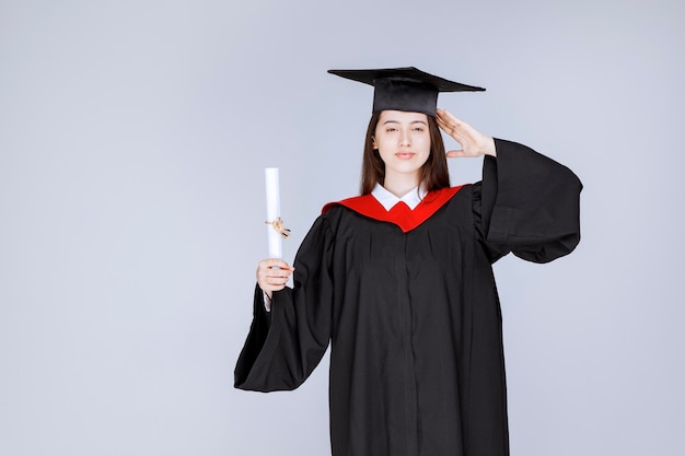 Graduate female student showing her diploma. High quality photo