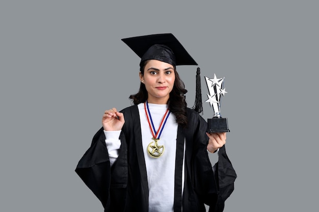 Graduate student girl presenting her trophy cup indian pakistani model