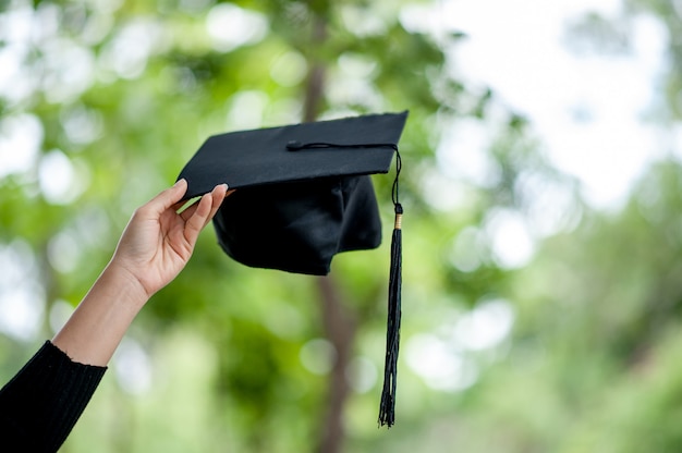 Graduates are expressing joy at graduation. 