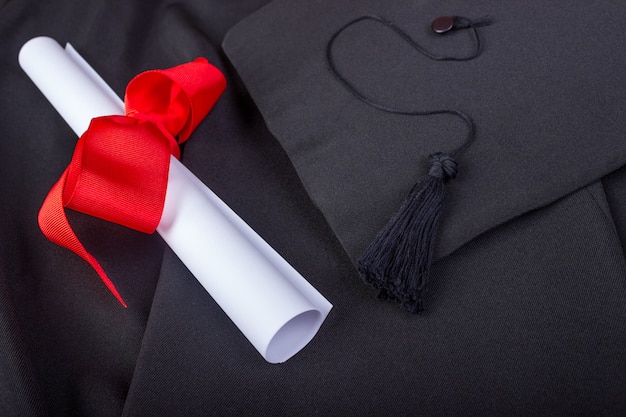 Photo graduation day. a gown, graduation cap, and diploma and laid out ready for graduation day