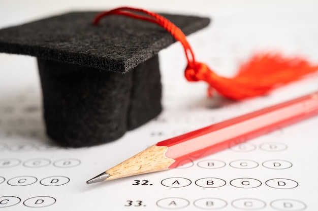 Graduation hat and pencil on Answer sheet background Education study mathematics learning teach concept