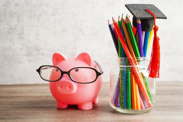 Graduation hat with colorful pencils on book with copy space learning university education concept