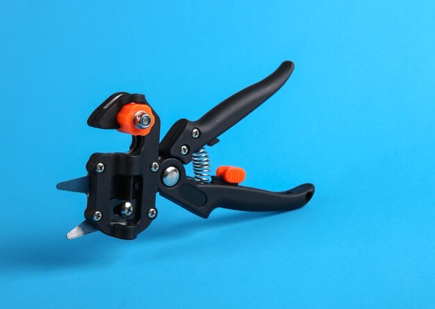 Grafting pruner for plants on blue background