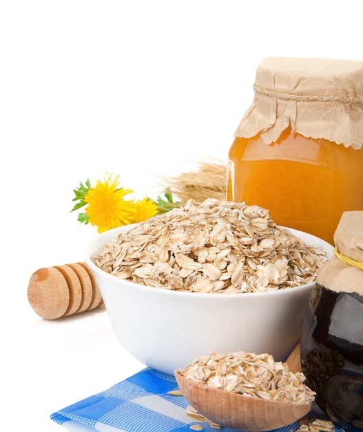 Grain cereal with honey and oatmeal isolated on white surface