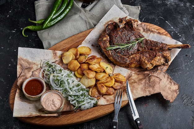 Grain fed Grilled Tomahawk Beef steak with fried potato wedge