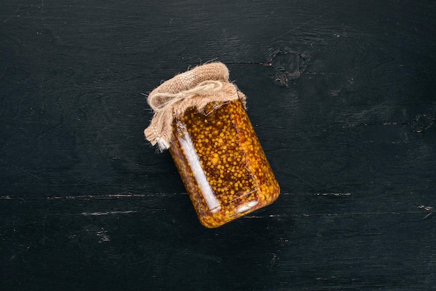 Grain Mustard Spices On a dark wooden background Top view Copy space for your text