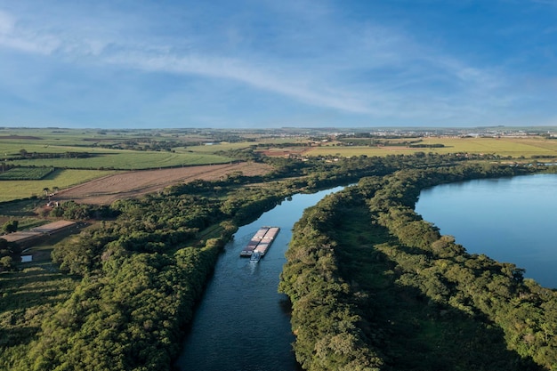 Grain transport barge going up the tiete river tieteparana waterway drone view