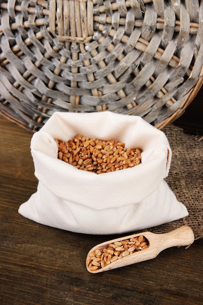 Grains in sack on wooden background