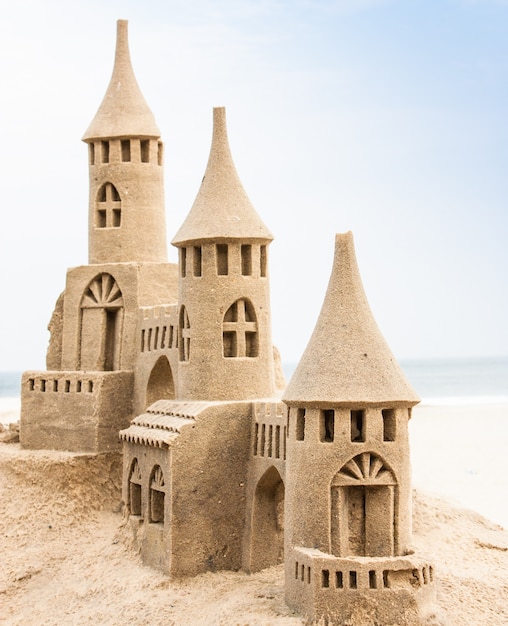 Grand sandcastle on the beach during a summer day