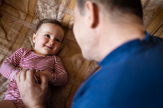 Granddaughter smiling and playing with her grandad