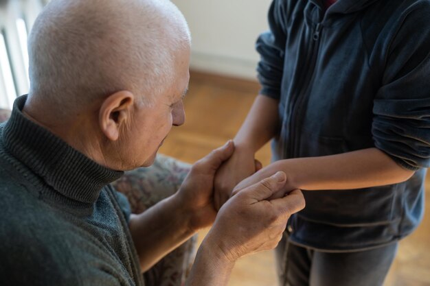 grandfather and granddaughter hands close up.