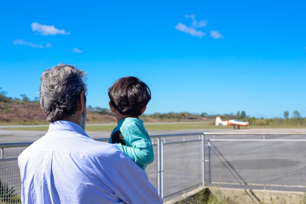 Grandfather and Grandson Watching the Planes at the Airport