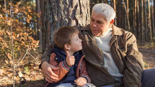 Grandfather  having fun with his grandchild outdoor.