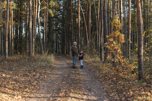 Grandfather  having fun with his grandchild outdoor.