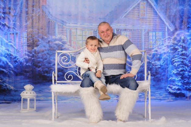 Grandfather and his grandson are having fun celebrating Christmas