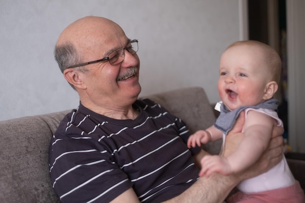 Grandfather holding a caucasian 8 month baby girl