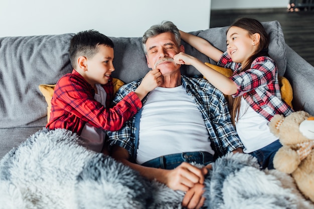 Grandfather sleeping next to kids