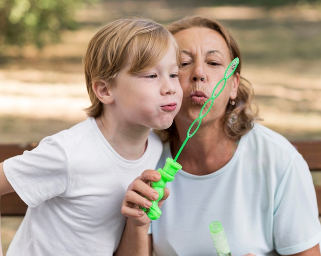 Photo grandma and boy  making balloons