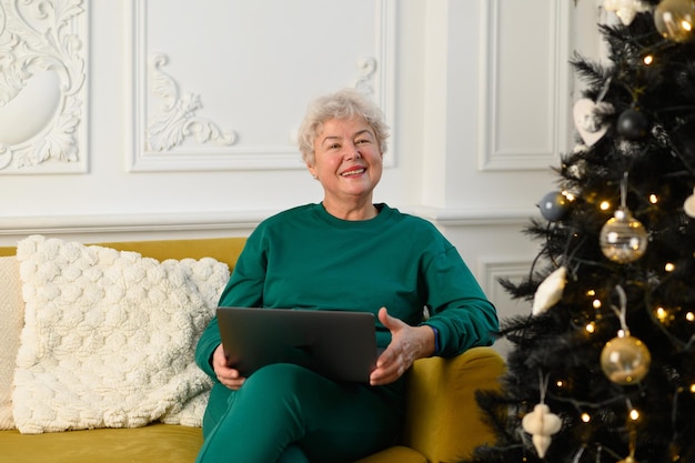 Grandma is talking on a video conference with her family modern means of communication high quality ...