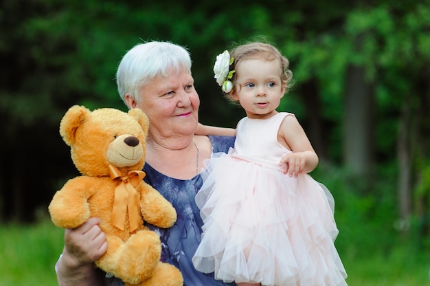 Grandmother and granddaughter walk in the park