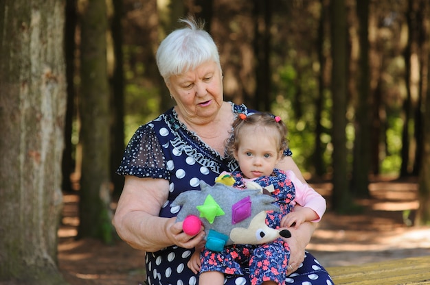 Grandmother and granddaughter walk in the park