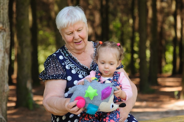 Grandmother and granddaughter walk in the park