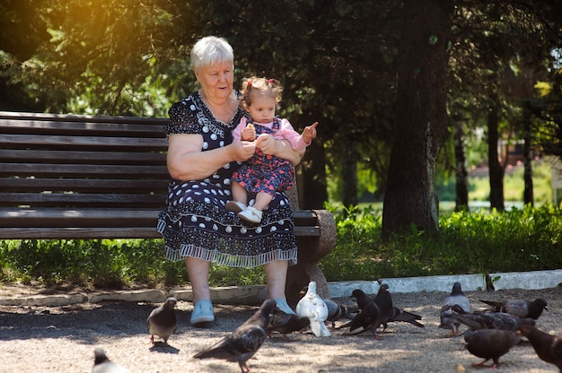 Grandmother and granddaughter walk in the park