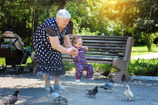 Grandmother and granddaughter walk in the park